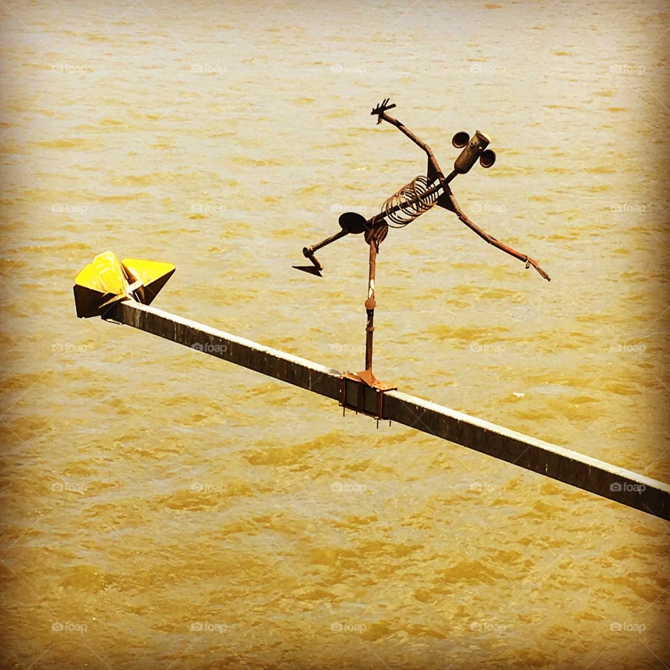 Balancing metal man over the river in Cologne Germany 