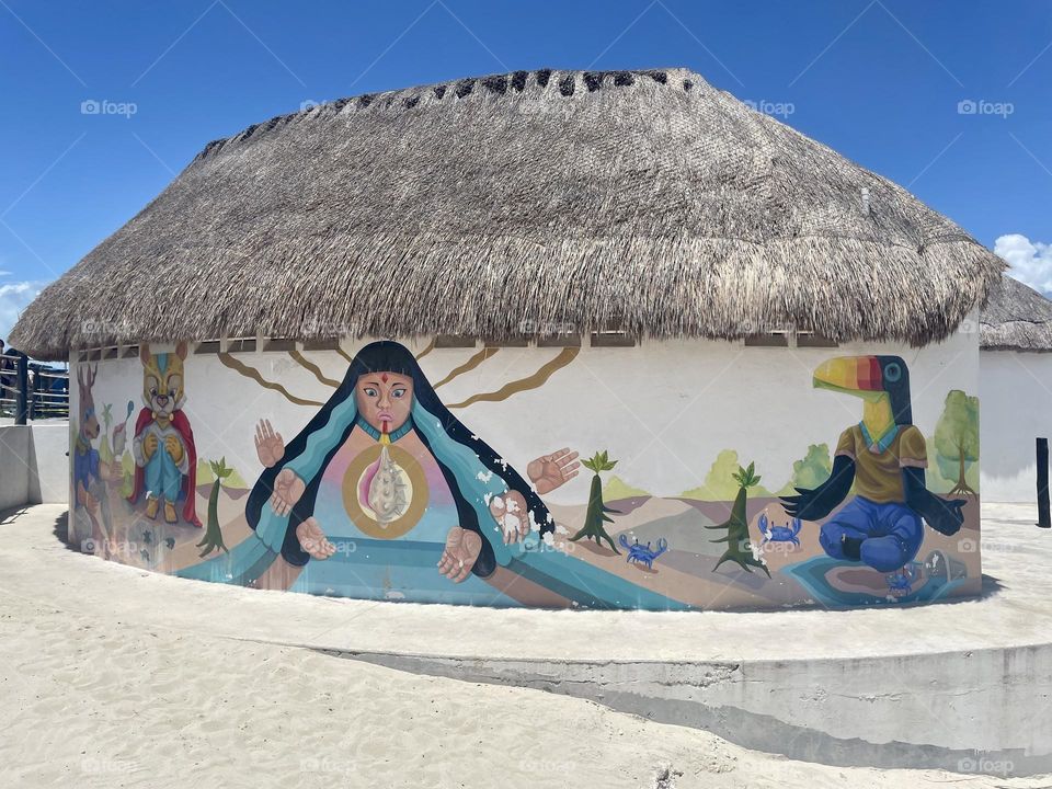 Mayan-themed mural by the beach Playa Delfines in Cancun, Mexico.