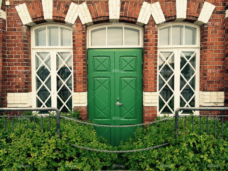 Green door in red brick building