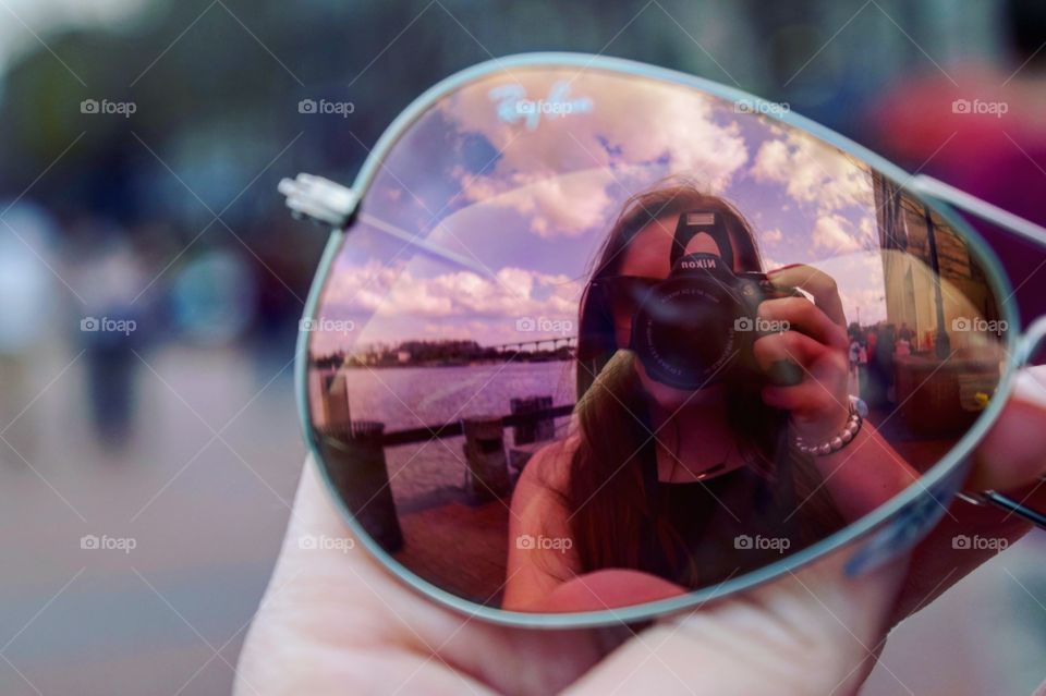 Reflection of woman in sunglasses in Savannah, GA