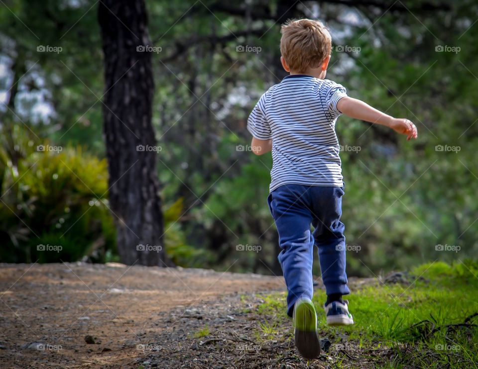on the run . Born to Run. 1 boy running in the forest