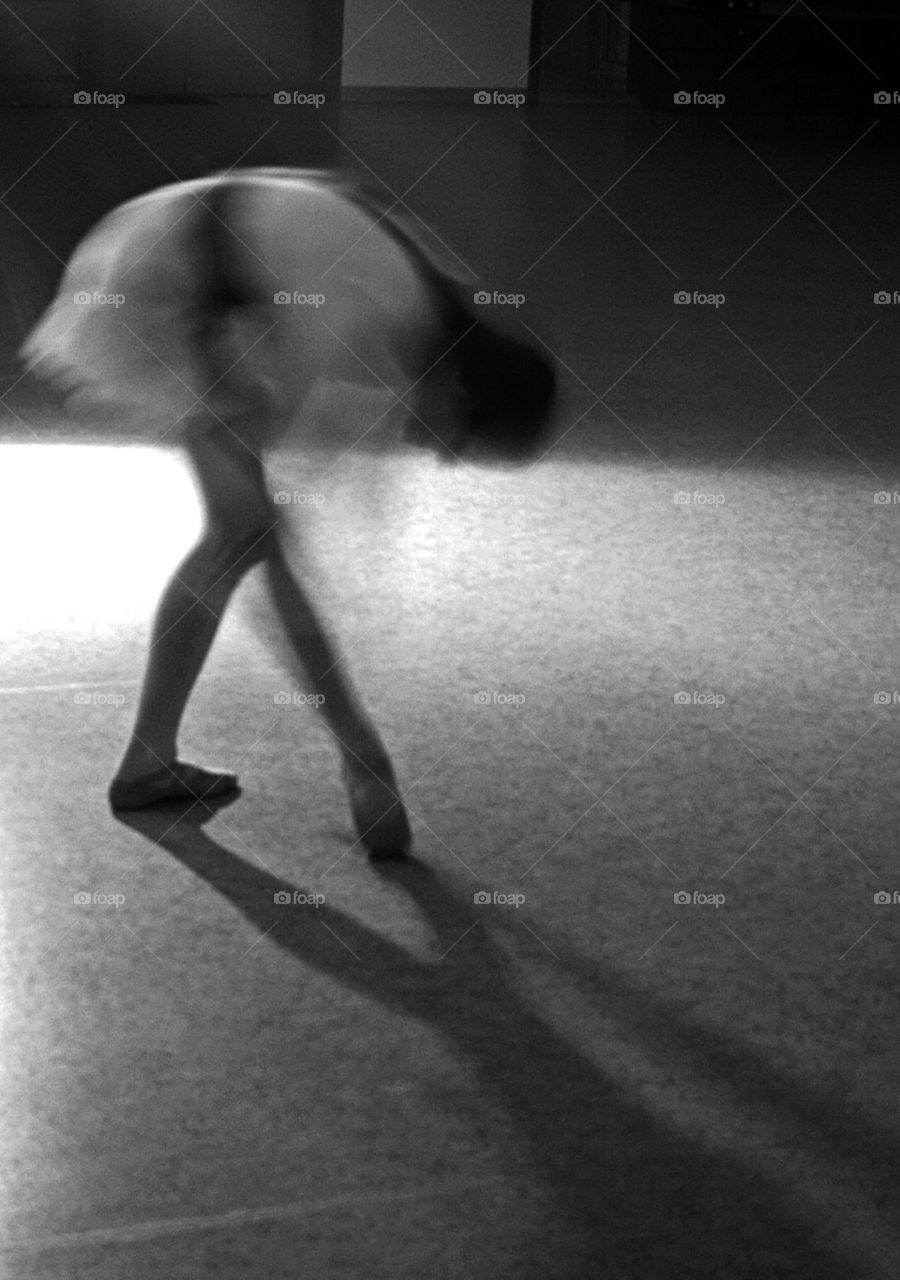 Ballerina in motion, shadows and light