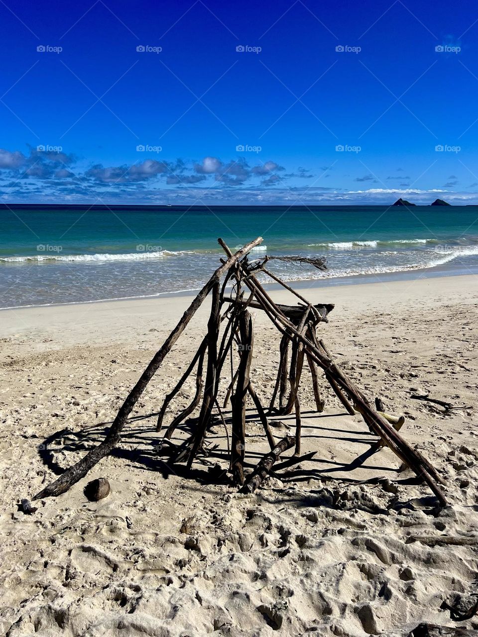 Driftwood teepee on Kailua Beach in Kailua Hawaii