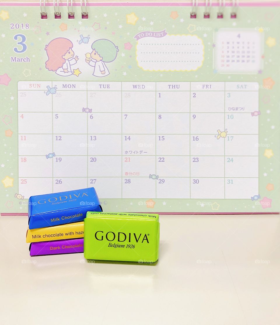 Bangkok, Thailand - March 12, 2018 : A photo of Godiva chocolate in many flavors and March 2018 calendar on the background. The calendar is Sanrio Japan product, with The Little Twin Stars, Sanrio characters. Editorial use only.