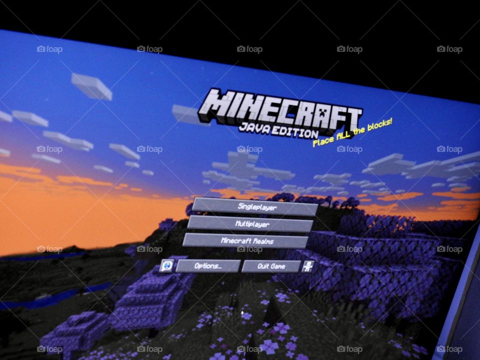 Video game photography taken of the game Minecraft from a gaming computer screen in a dark room at the start of the game showing the menu from the start.