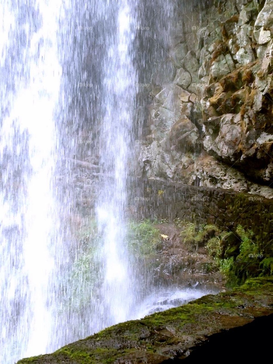 Behind the waterfall