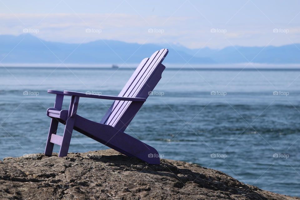 A lounge chair on the rocky shore 