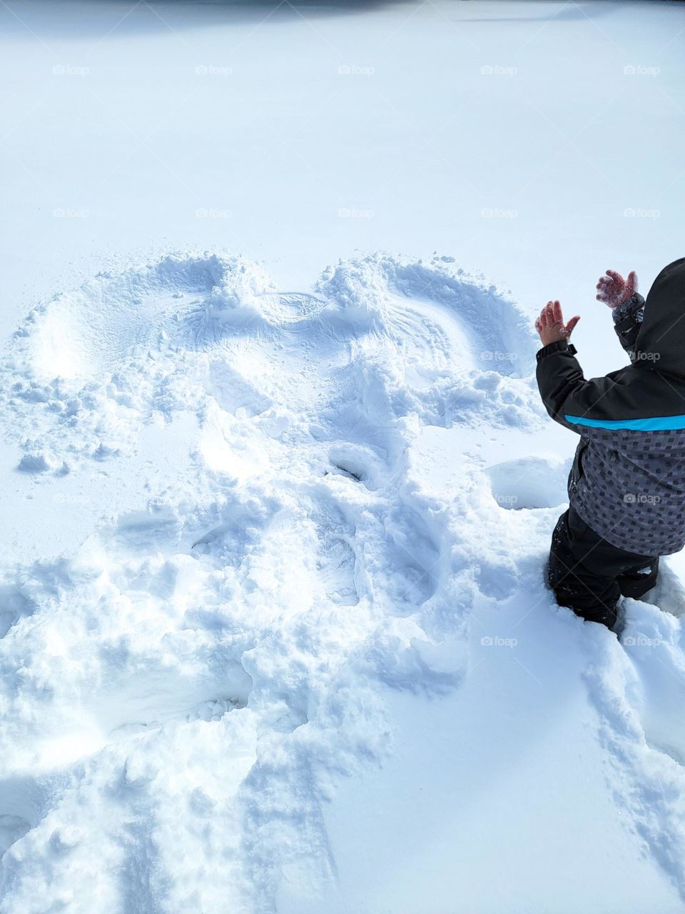 Beautiful snow angel making on a snowy day.
