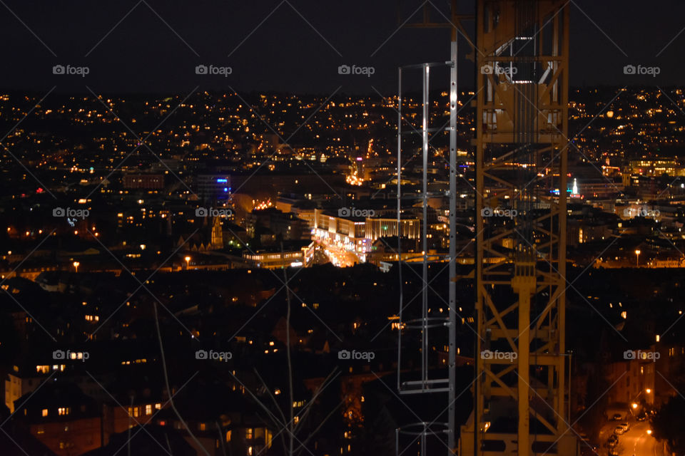 view of a big city and a cran by night