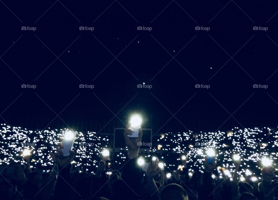 Audience lit by mobile phones