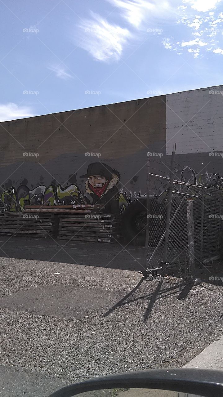 Warehouse graffiti. Driving through the alley