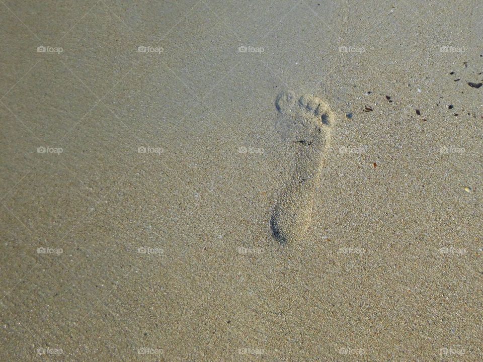 Footprint on the sand. Barefoot right foot
