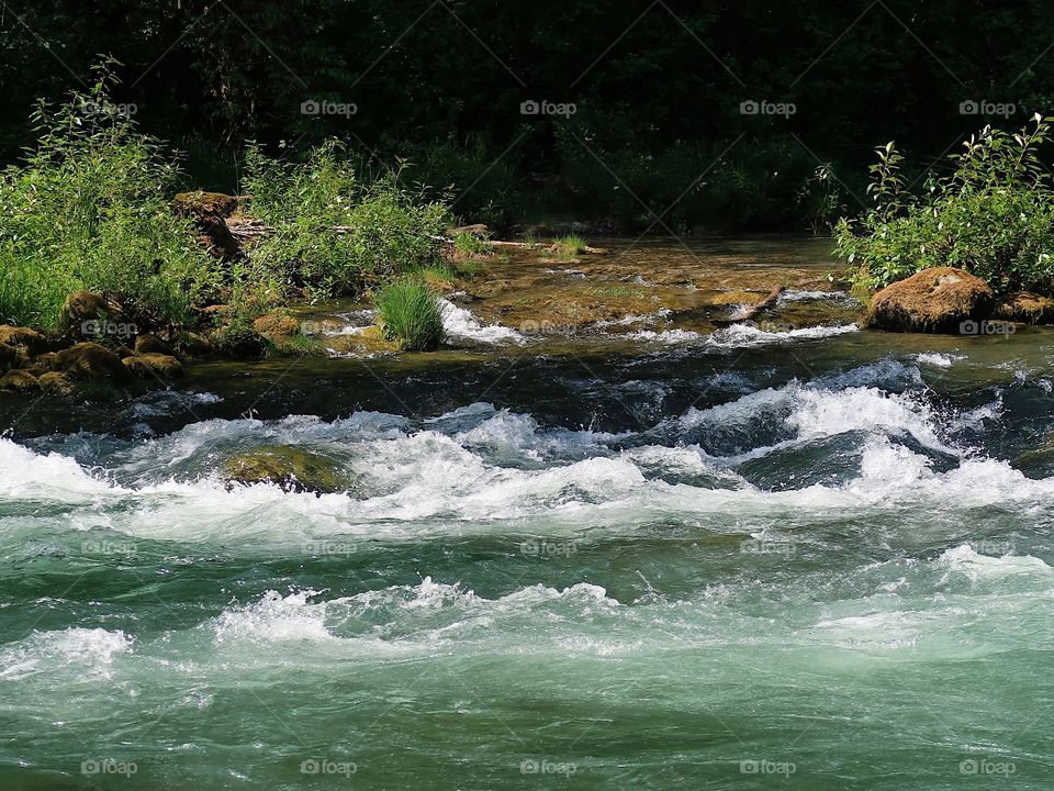 The incredible turquoise waters of the Blue River in the Willamette National Forest on a sunny spring day. 