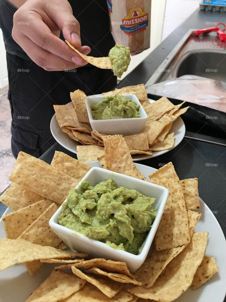 Close up spinach hummus dip with corn chips