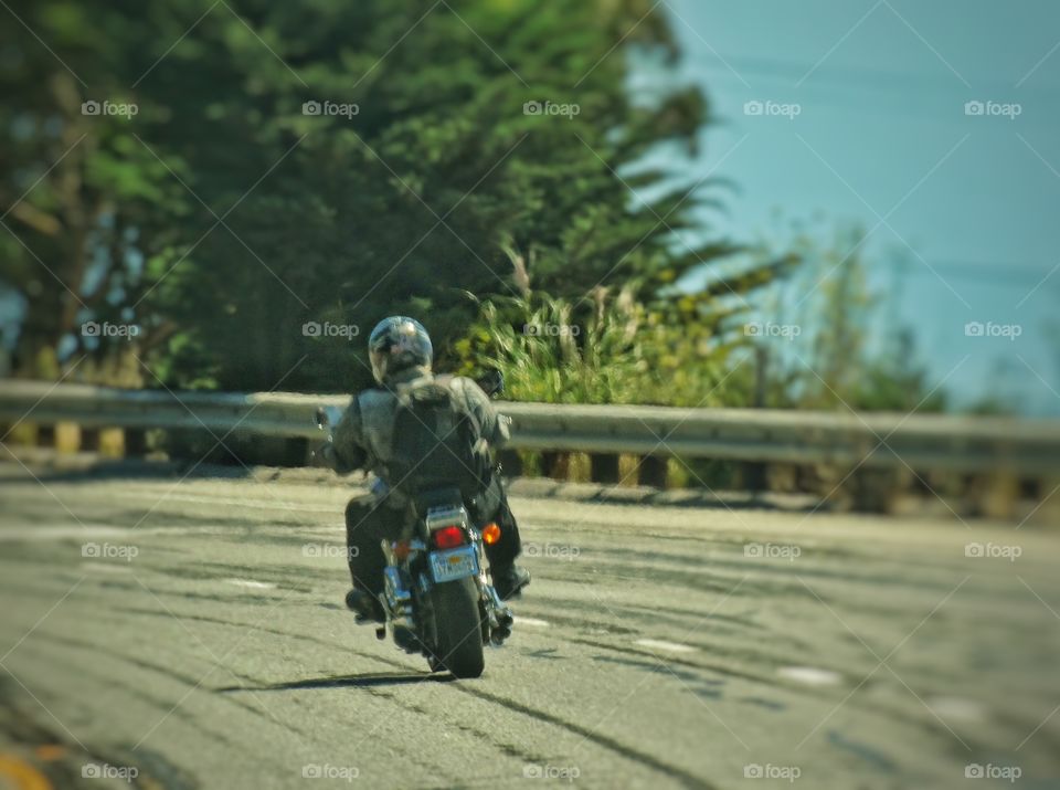 Lone Motorcycle Rider. Motorcyclist Driving On California's Pacific Coast Highway
