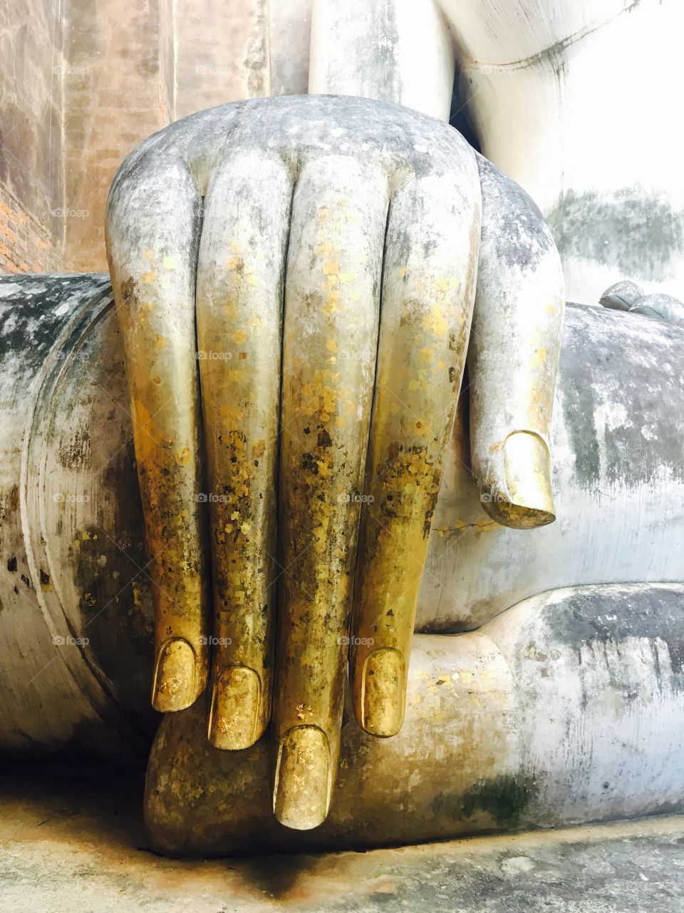 Closeup hand of buddha statue at Wat sri chum temple, Sukhothai, Thailand, UNESCO world heritage 