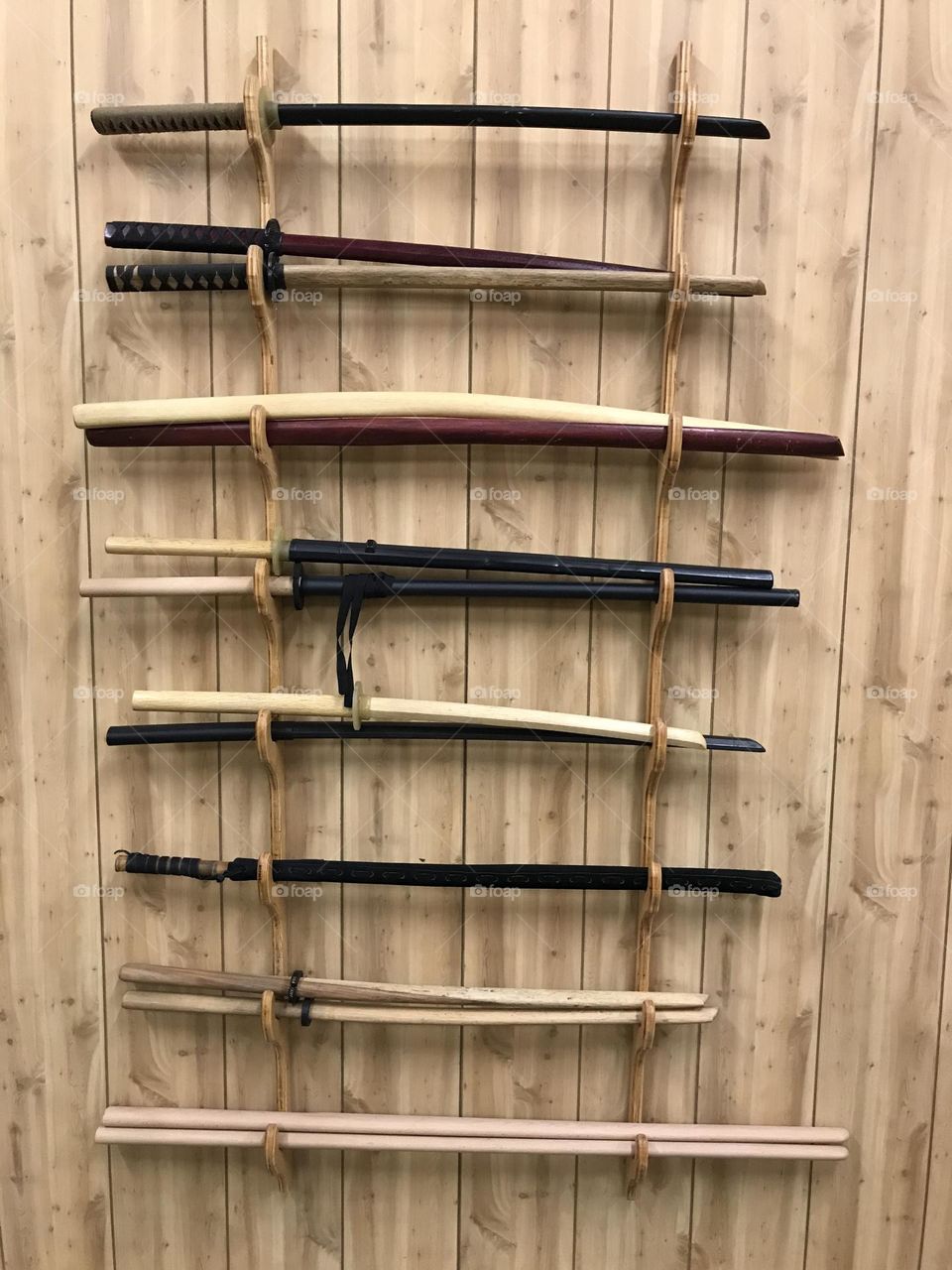 A weapon rack in the Japanese martial arts dojo. Any of these training weapons is used to improve and sustain my personal health and fitness.