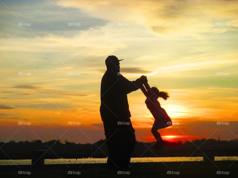 Silhouette of father and daughter