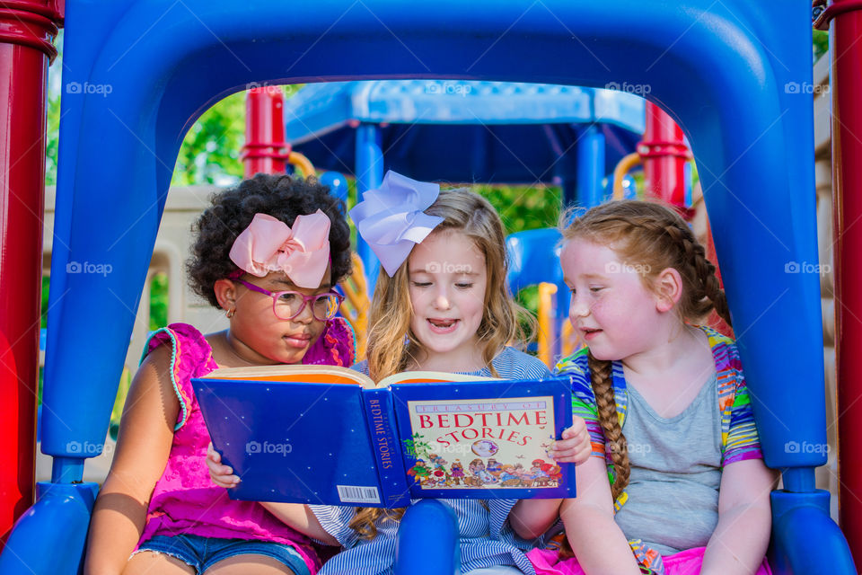 Three Girls Reading on the Playground 