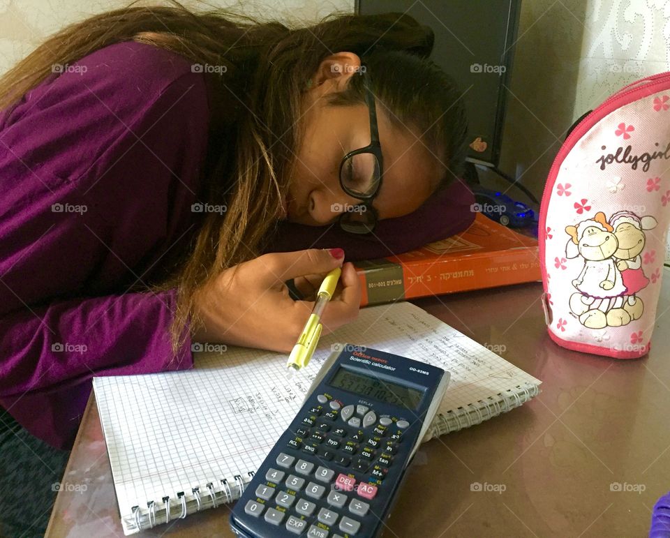 Close-up of girl slept while studying