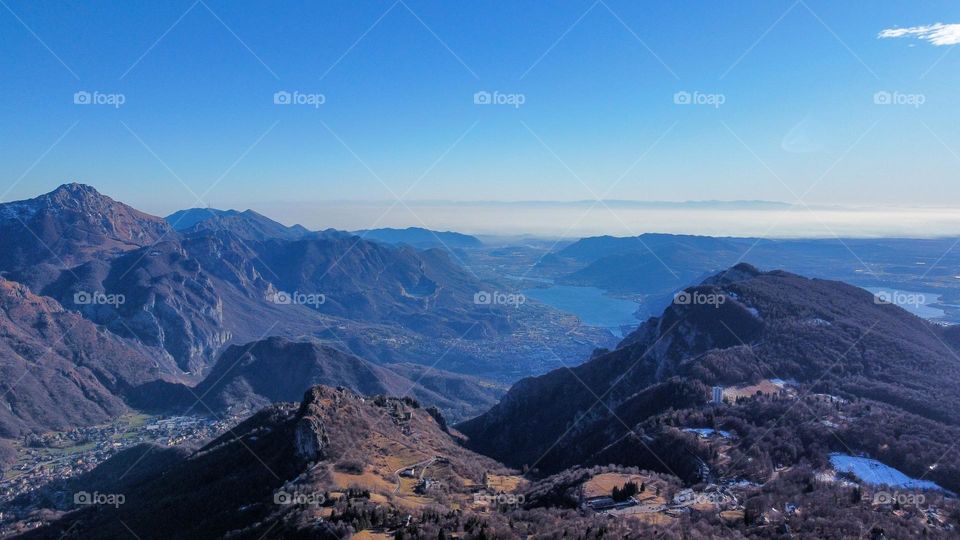 Landscapes with mountains. Area view with shades of colors, blue water and green meadows