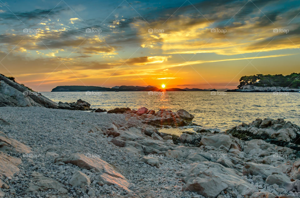 Sunset over rocky beach