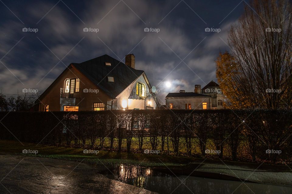 Residental house at night with warm light in the windows