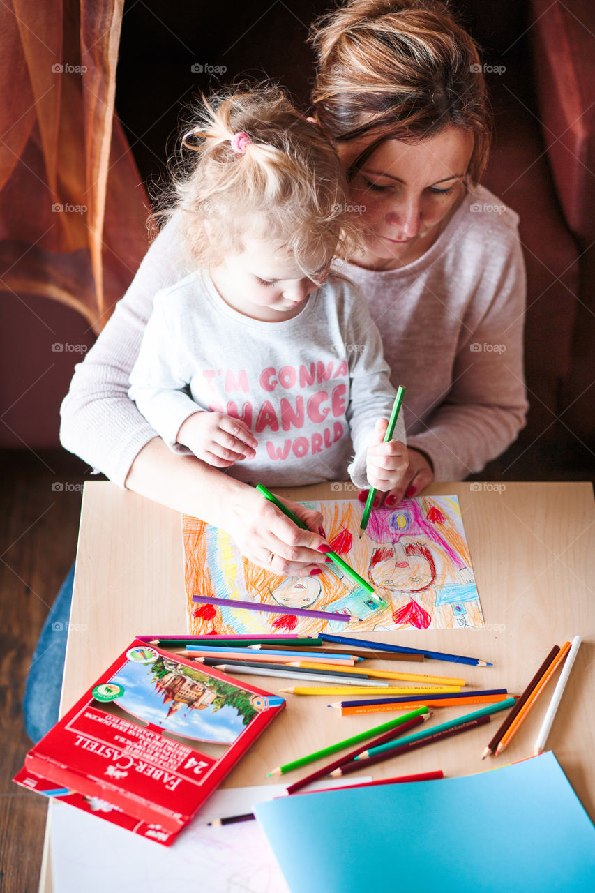 Colours of the world. Children with mom drawing using crayons