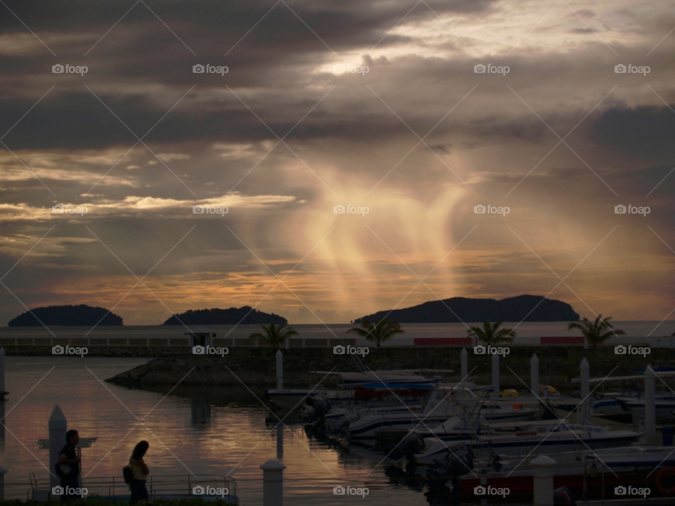 sunset clouds boats rain by botie2