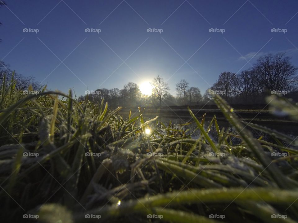 Countryside sunrise showing the colorful sky over the frozen grass