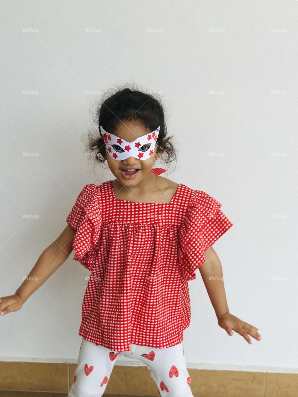 A girl dancing with eye masks.