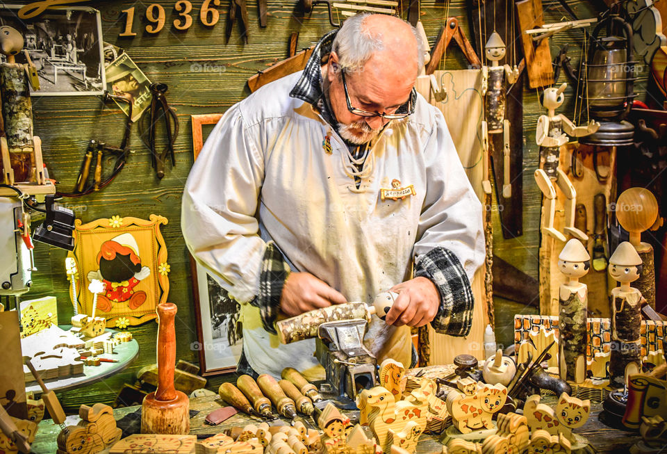 A Craftsman Working In The Workshop Making Wooden Toys