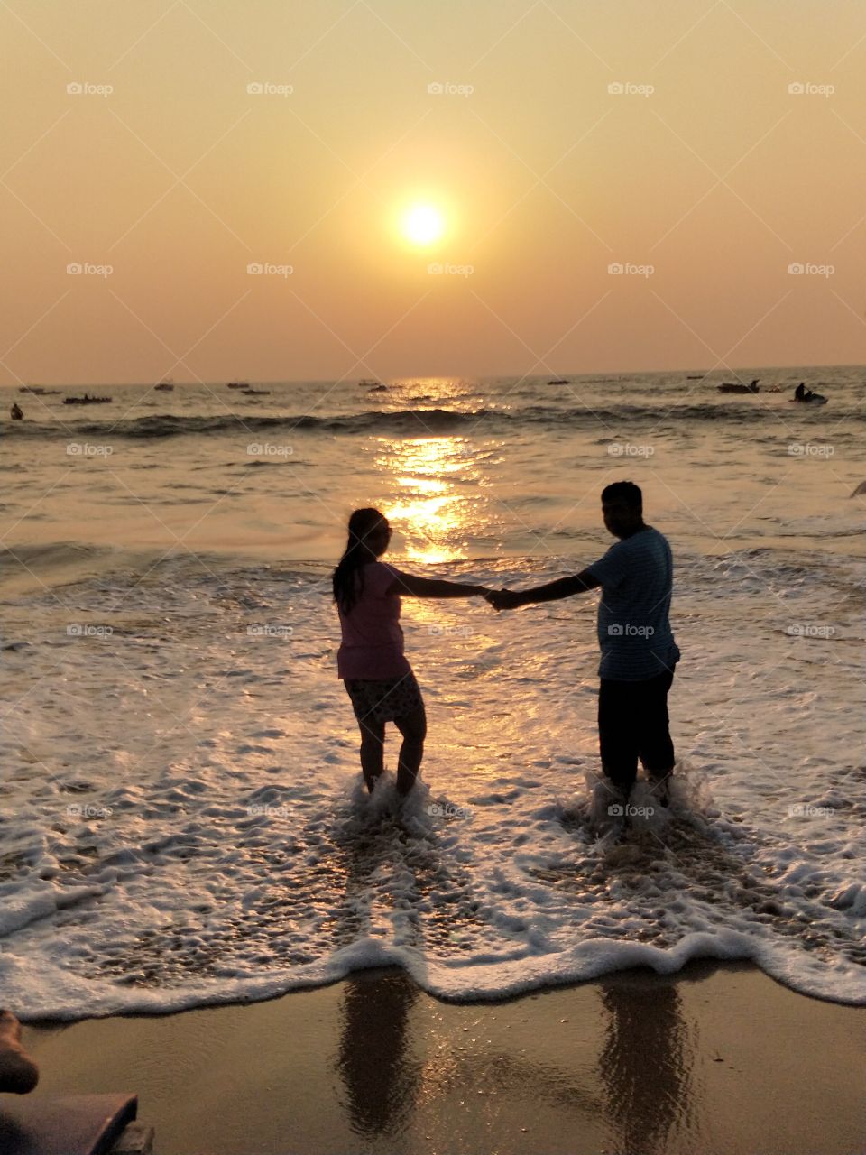dawn of the day. sunset time. couple at the beach at sunset time. sea, ocean, romance, nature, evening