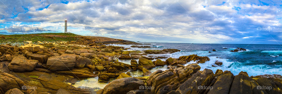 Cape Leeuwin lighthouse dwarfed by rocky outcrops at Augusta in South West Western Australia