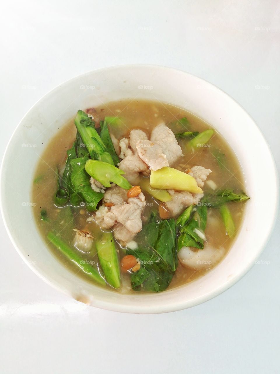 Fried noodles soup with pork and broccoli.
