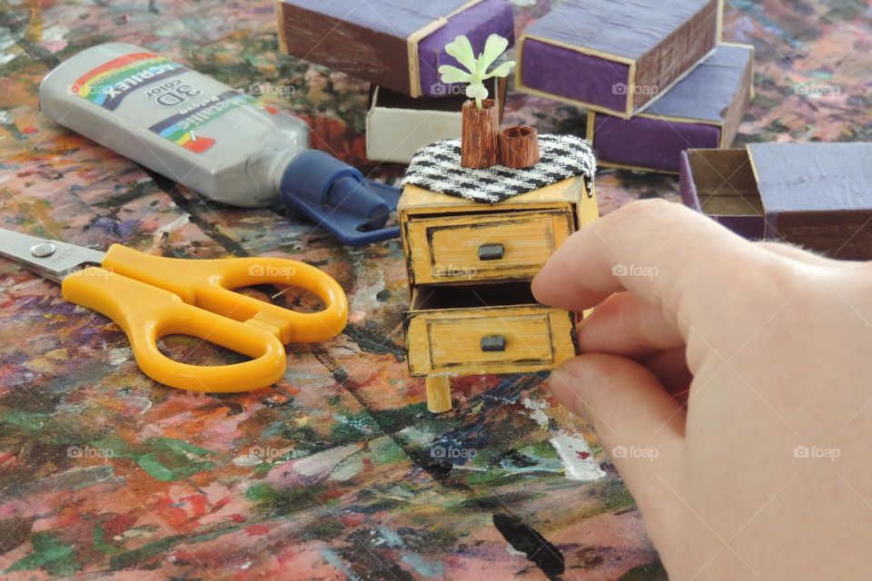 Miniature nightstand with matchboxes.