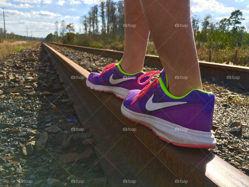 Pop of color walking along dull tracks