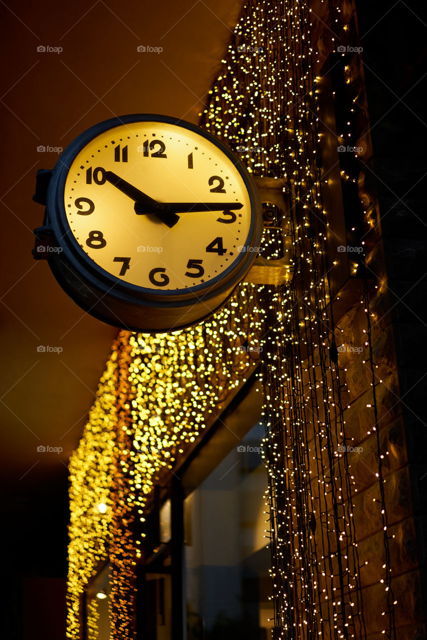 Street clock and  festive lights 