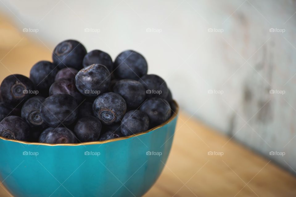 Closeup of fresh blueberry stack high in bowl closeup healthy eating background with room for copy 