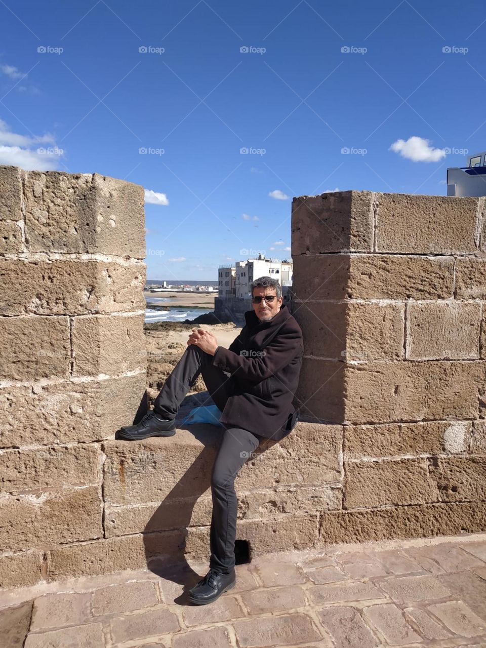 Im sitting on ancient wall at essaouira city in Morocco