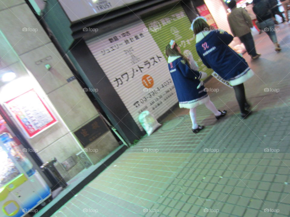 Akihabara, Tokyo, Japan.  Maids from a maid cafe, walking