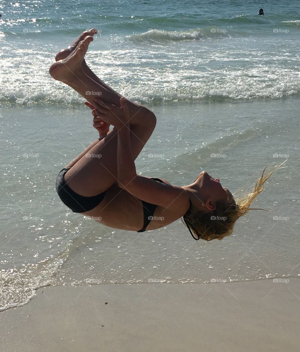 girl flipping on beach