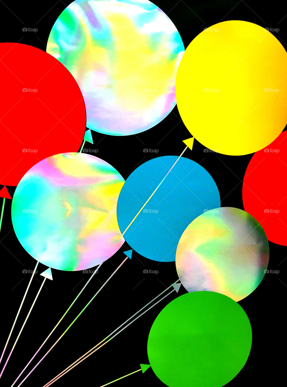 Multicolored balloons against black background
