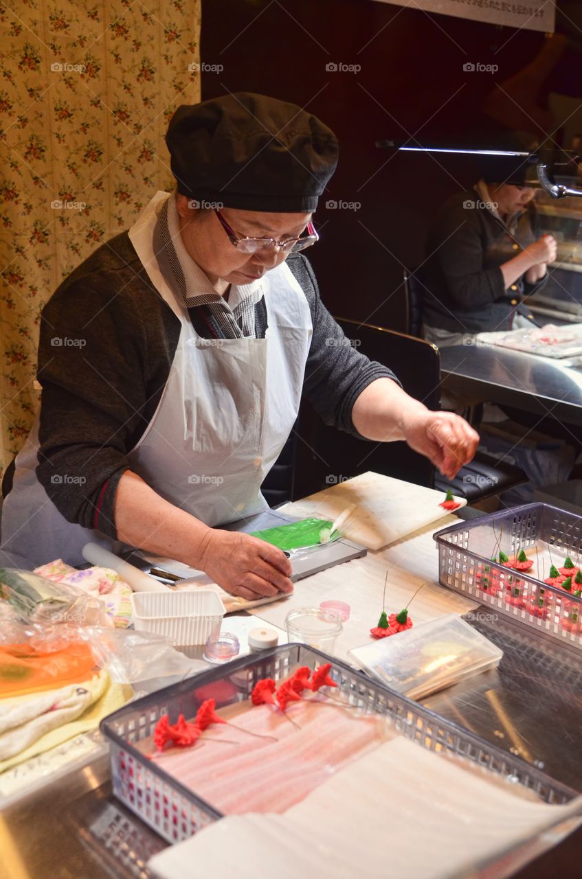 Pastry chef preparing some chocolates and sweets