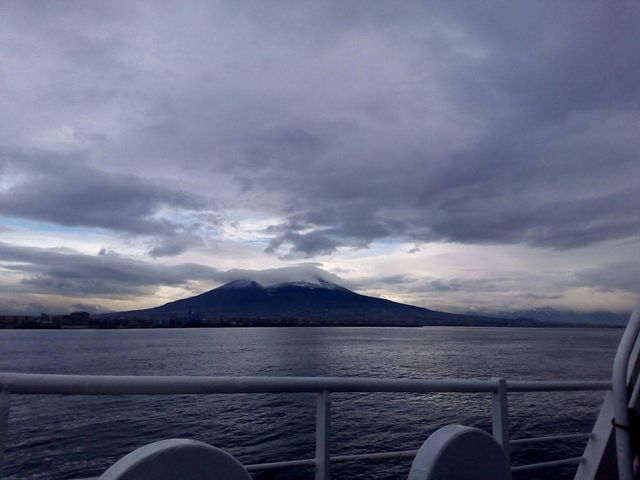 Mount Vesuvio full of snow seen by the ferry at the dawn