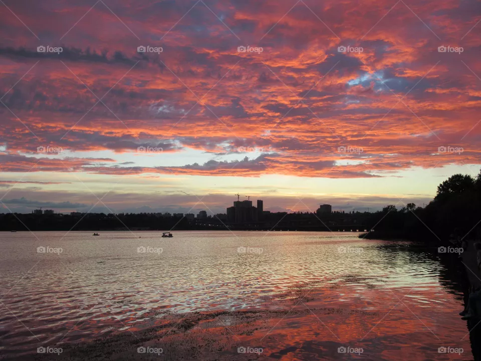 sunset in the summer in the city, crimson clouds and clouds