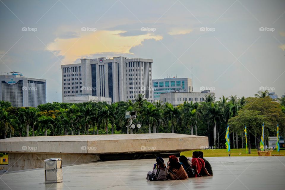 Visitors are sitting below Monas Museum