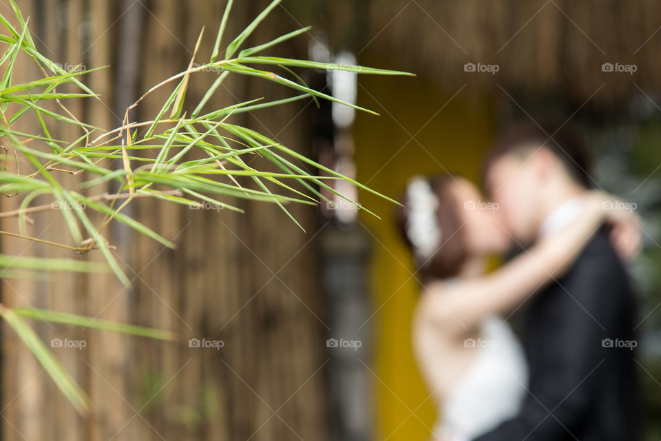 Couple kissing near plant