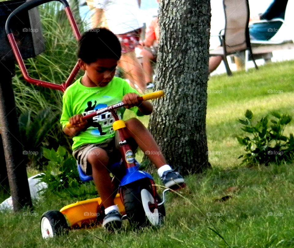 Young biker. Young boy biking