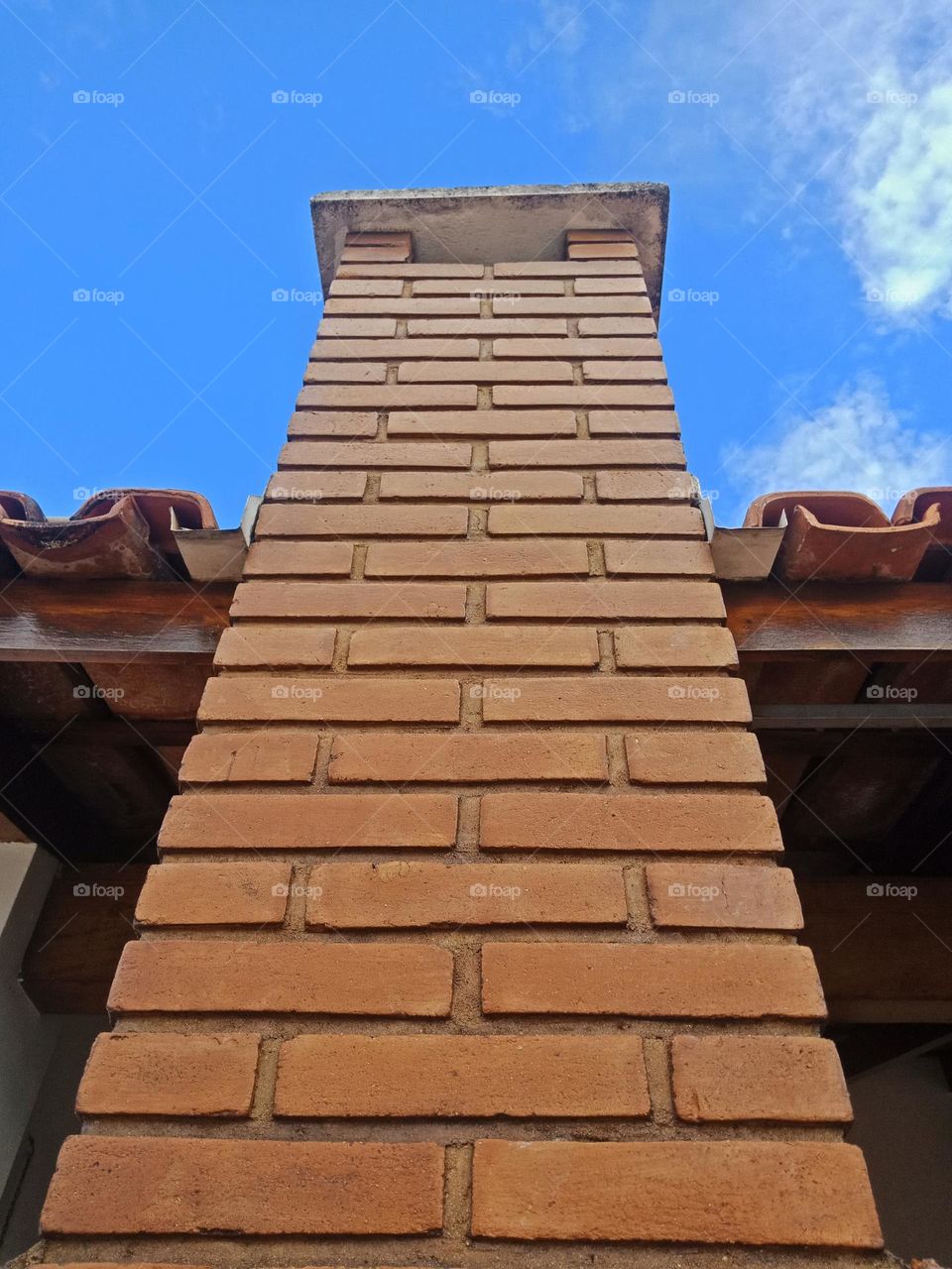 brick chaminey against a blue sky